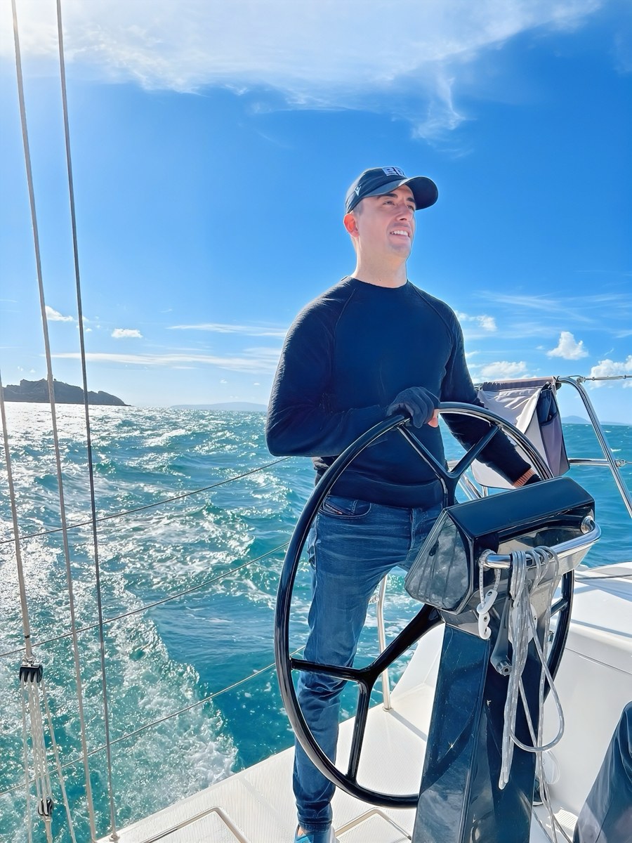 Ervin Ukaj at the helm of a sailing boat